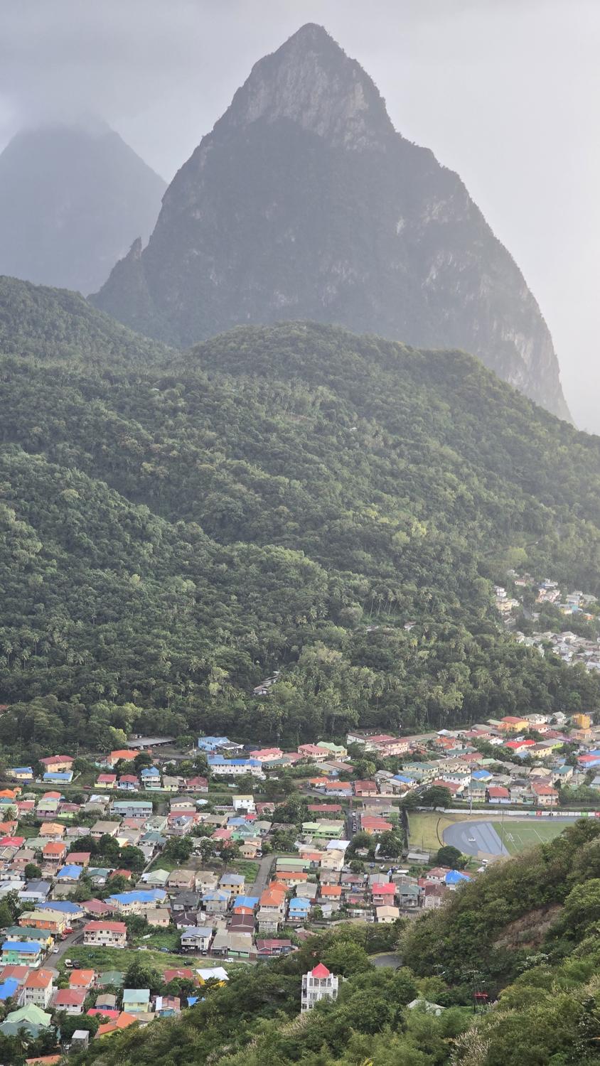 Petit Piton rising above the coloured roofs of Soufrière